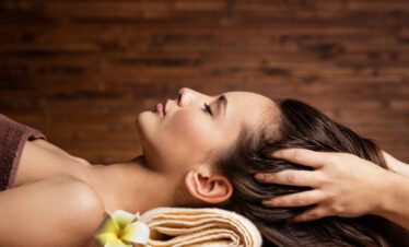 masseur doing massage the head and hair for an woman in spa salon